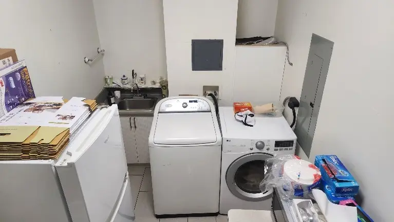 Dedicated laundry room with washer, dryer, refrigerator and utility area