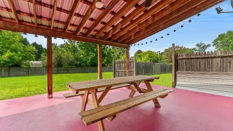 Covered patio and spacious backyard with outdoor expansion potential