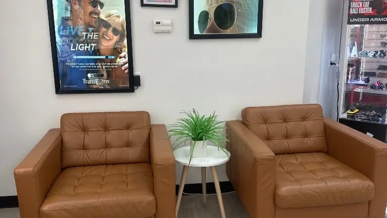 Comfortable and welcoming customer waiting area with modern furnishings and professional optical retail environment.
