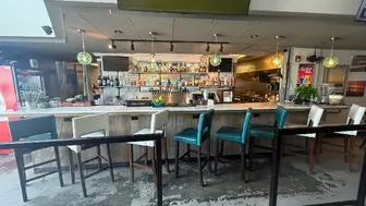 Alki Restaurant, beachfront bar & grill with sidewalk seating.