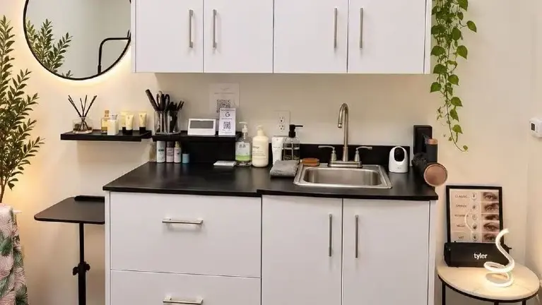 Modern cabinetry, built-in sink, spacious storage and organized beauty supplies for convenient daily operations.
